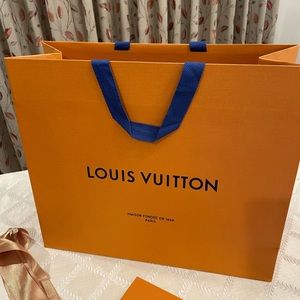 Louis Vuitton shopping bag with receipt folder and gold ribbon